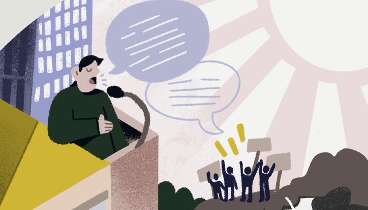 Man speaking at microphone to audience